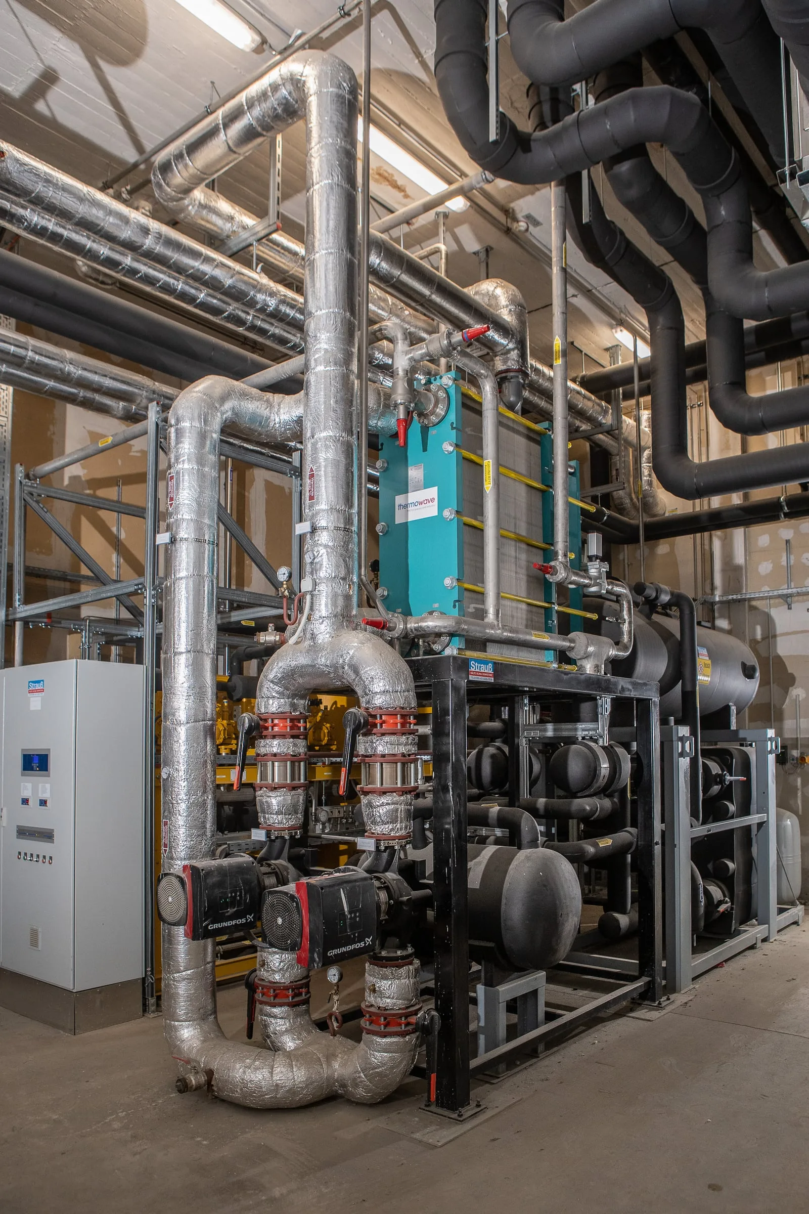 Ammoniak-Kälteanlage im Hochformat, isolierte Leitungen führen nach oben